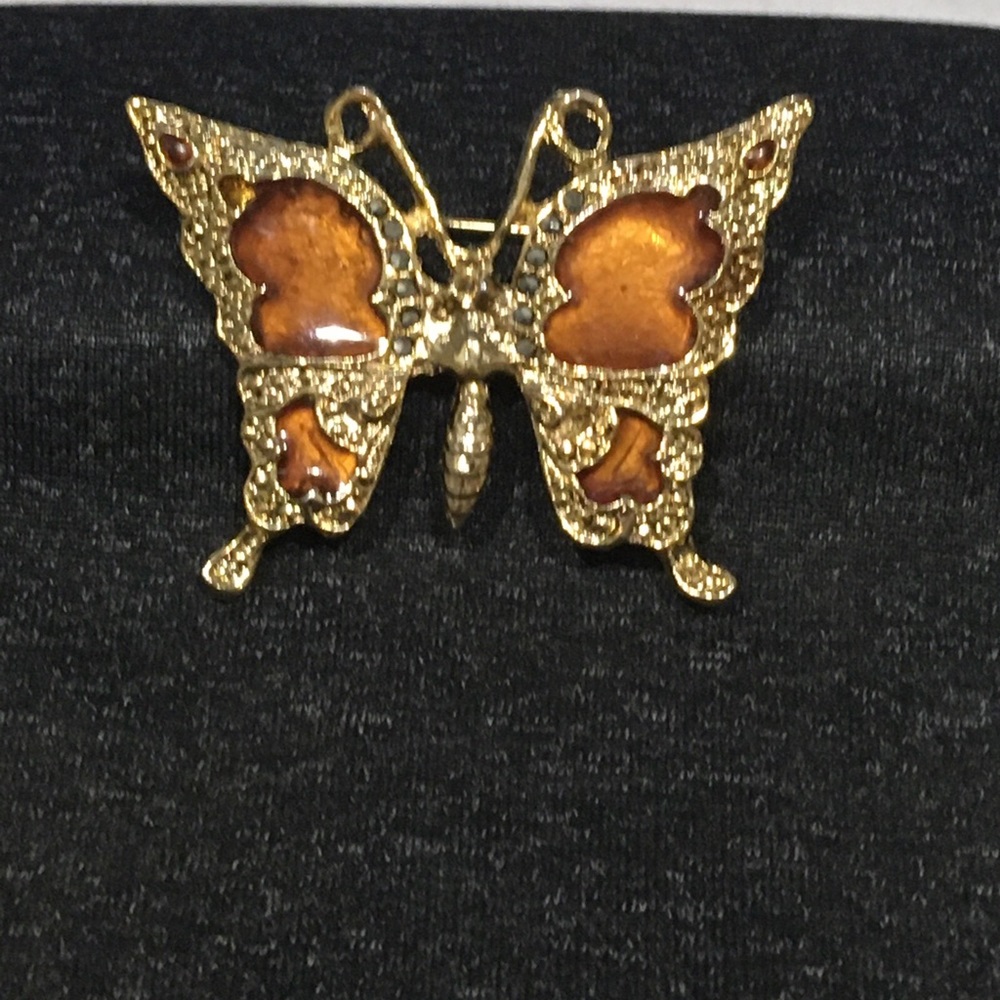Gold tone and amber butterfly brooch with black rhinestones.